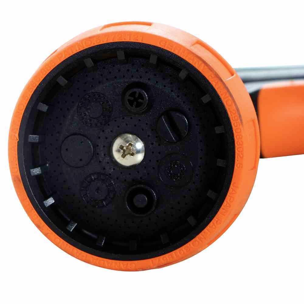 Nahaufnahme eines orange-schwarzen runden Steckers mit Schraube in der Mitte, geeignet für den Anschluss elektrischer Geräte.