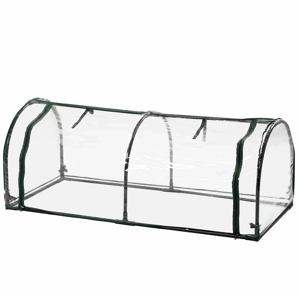 Ein Mini-Gewächshaus mit durchsichtigem Kunststoff und Metallrahmen, ideal für die Anzucht von Pflanzen im Garten oder Balkon.