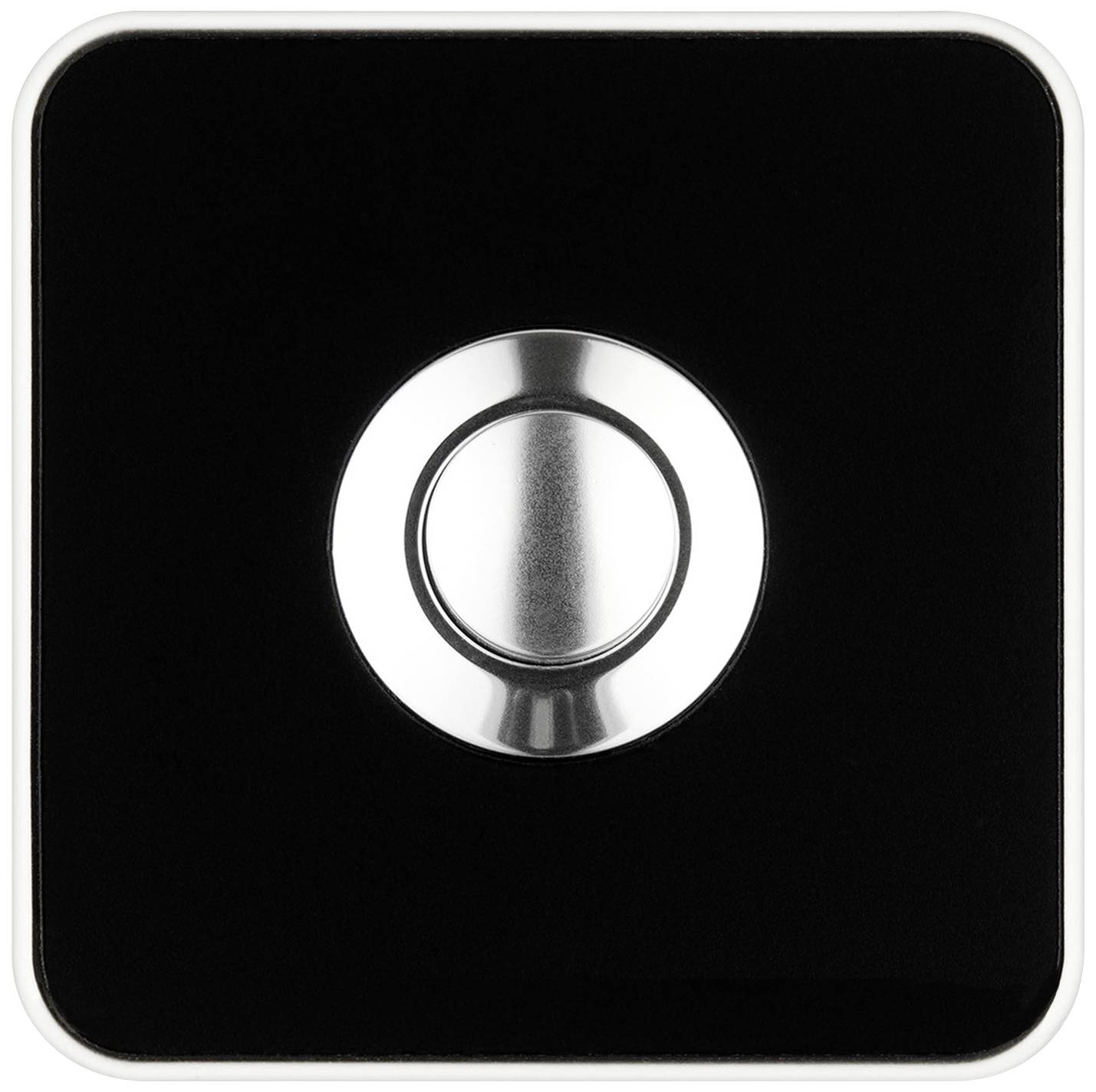 Ein moderner Lichtschalter mit schwarzer Oberfläche und silbernem Knopf in der Mitte.