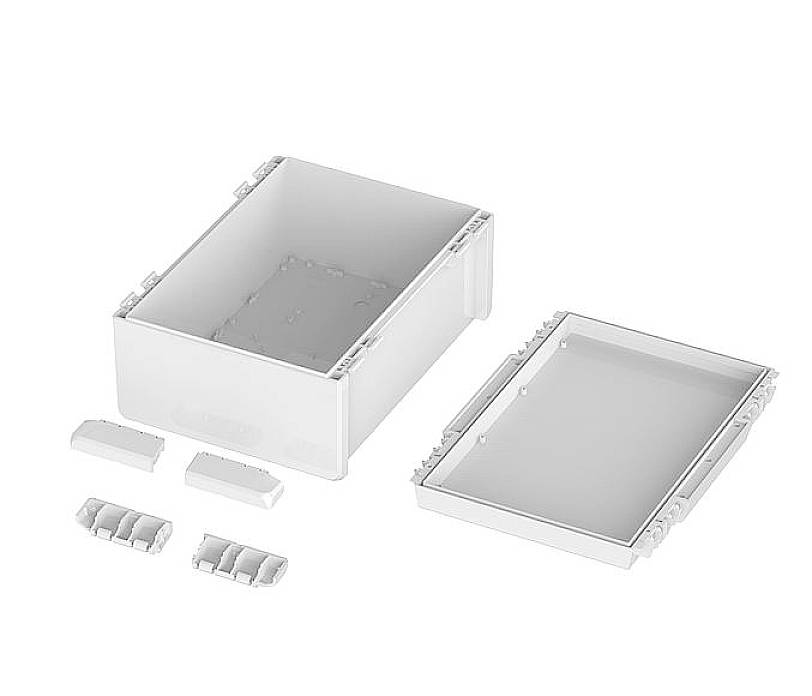 Rechteckiger, offener Kunststoffkasten mit abgenommener Abdeckung und vier kleinen separaten Bauteilen, auf weißem Hintergrund.