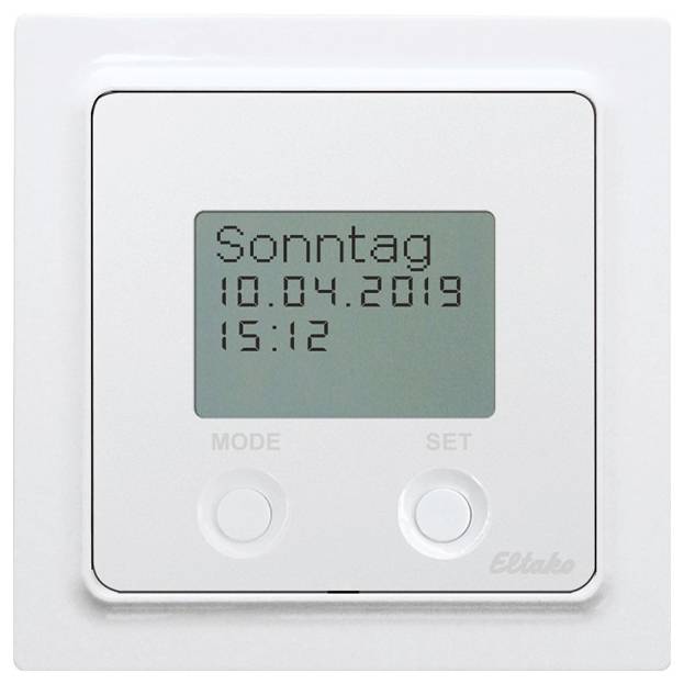 Digitaler Timer an der Wand zeigt 'Sonntag 10.04.2019 15:12'. Darunter befinden sich zwei Tasten mit der Beschriftung 'MODE' und 'SET'.