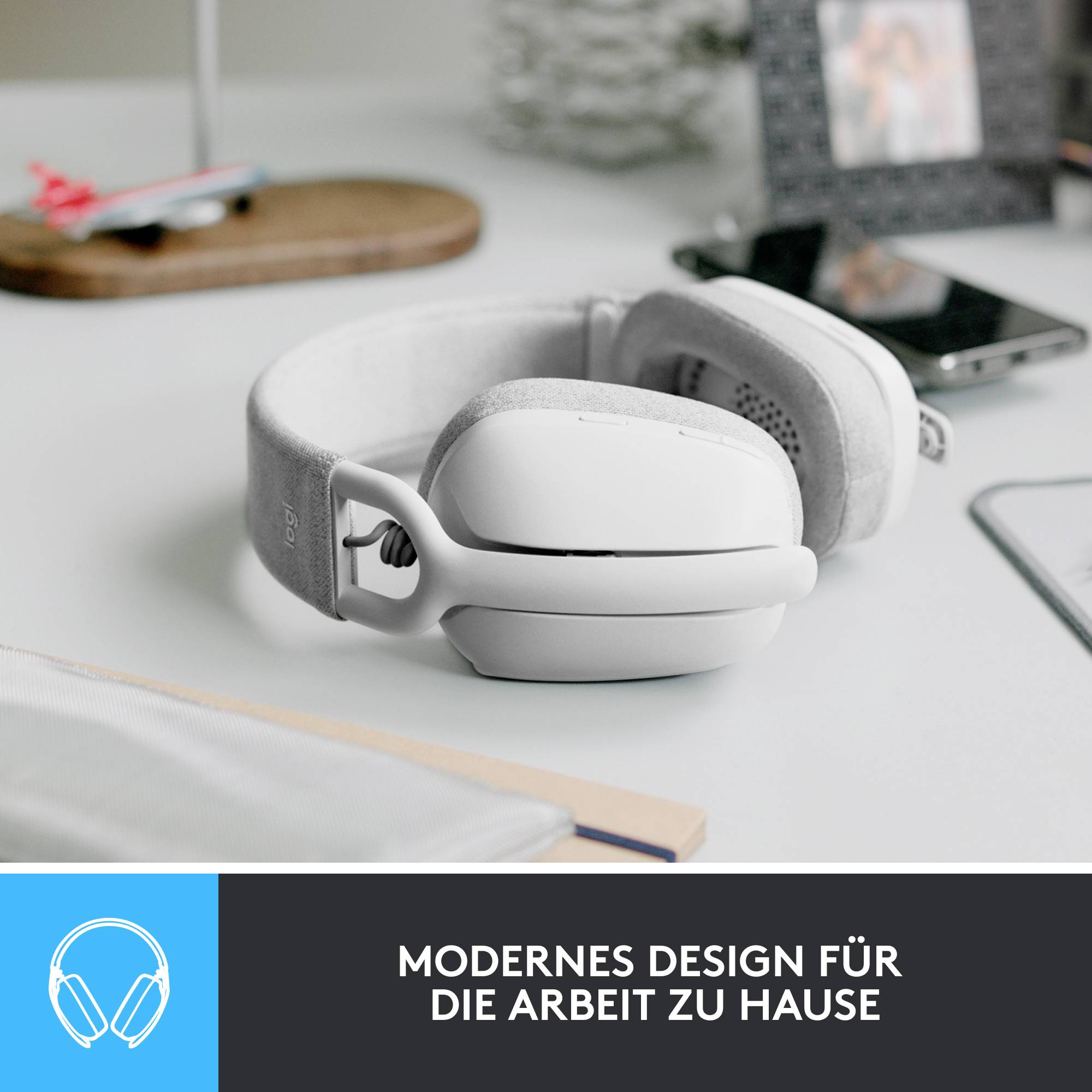 Kabellose, weiße Kopfhörer liegen auf einem Tisch. Darunter steht: 'Modernes Design für die Arbeit zu Hause'.