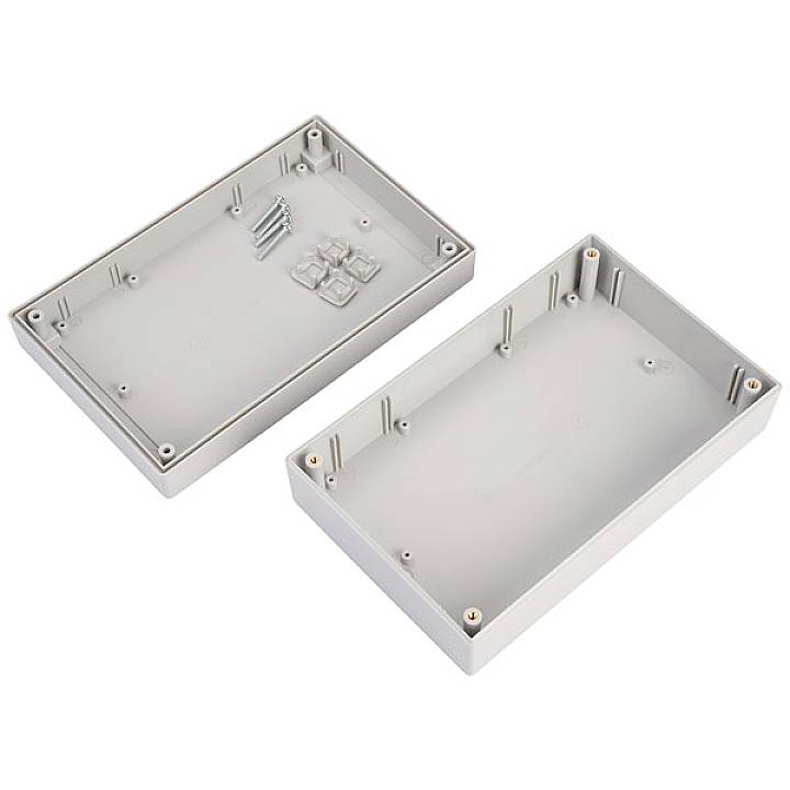 Zwei rechteckige Kunststoffgehäuse, eines geöffnet und eines geschlossen, mit Schrauben in der Mitte.