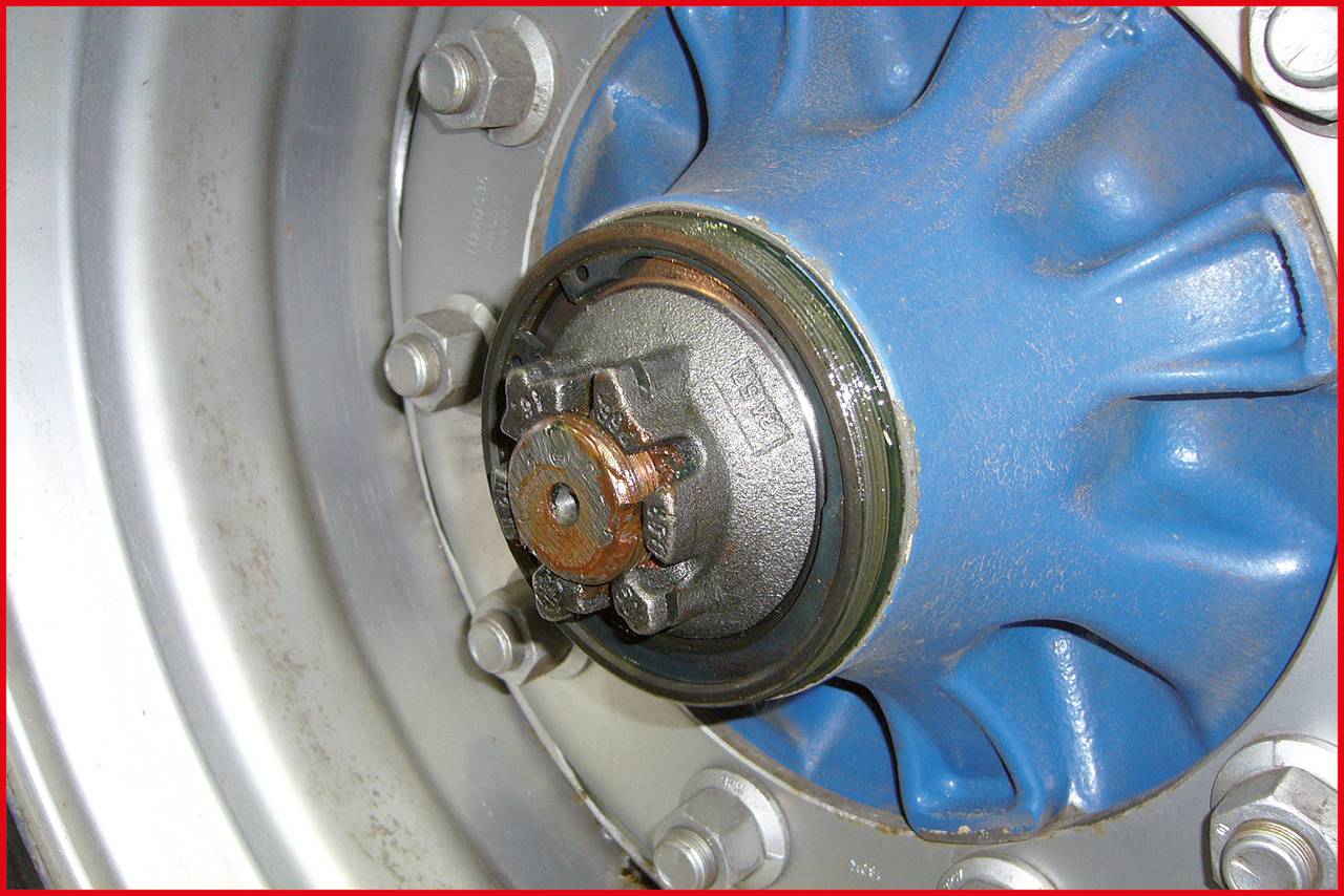 Nahaufnahme eines blauen Radzentrums mit Metallmuttern, die eine zentrale Scheibe umgeben.