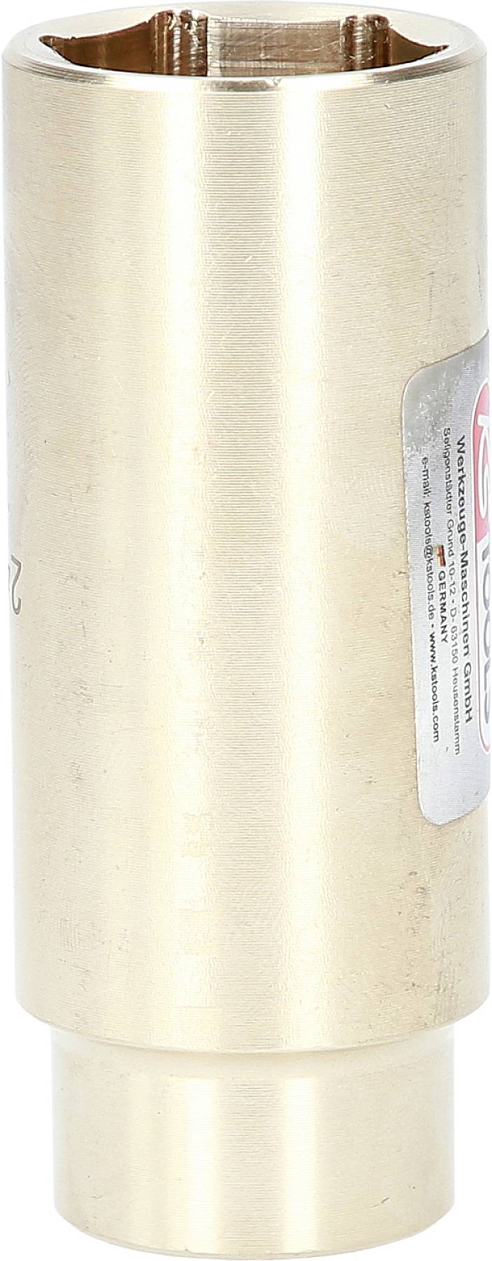 Ein länglicher, zylinderförmiger Metallgegenstand aus Messing mit einem Aufkleber auf der Seite.