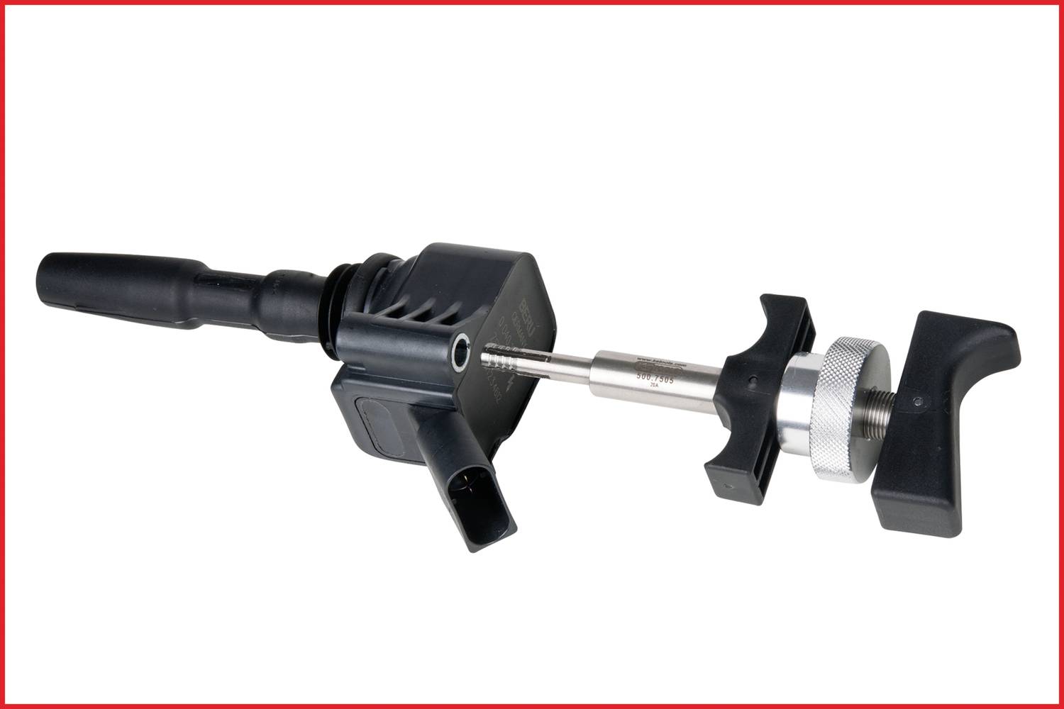 Ein schwarzes Zündspulenwerkzeug mit Metallteil und zwei Haltegriffen, das zur Reparatur oder Montage von KFZ-Zündsystemen verwendet wird.