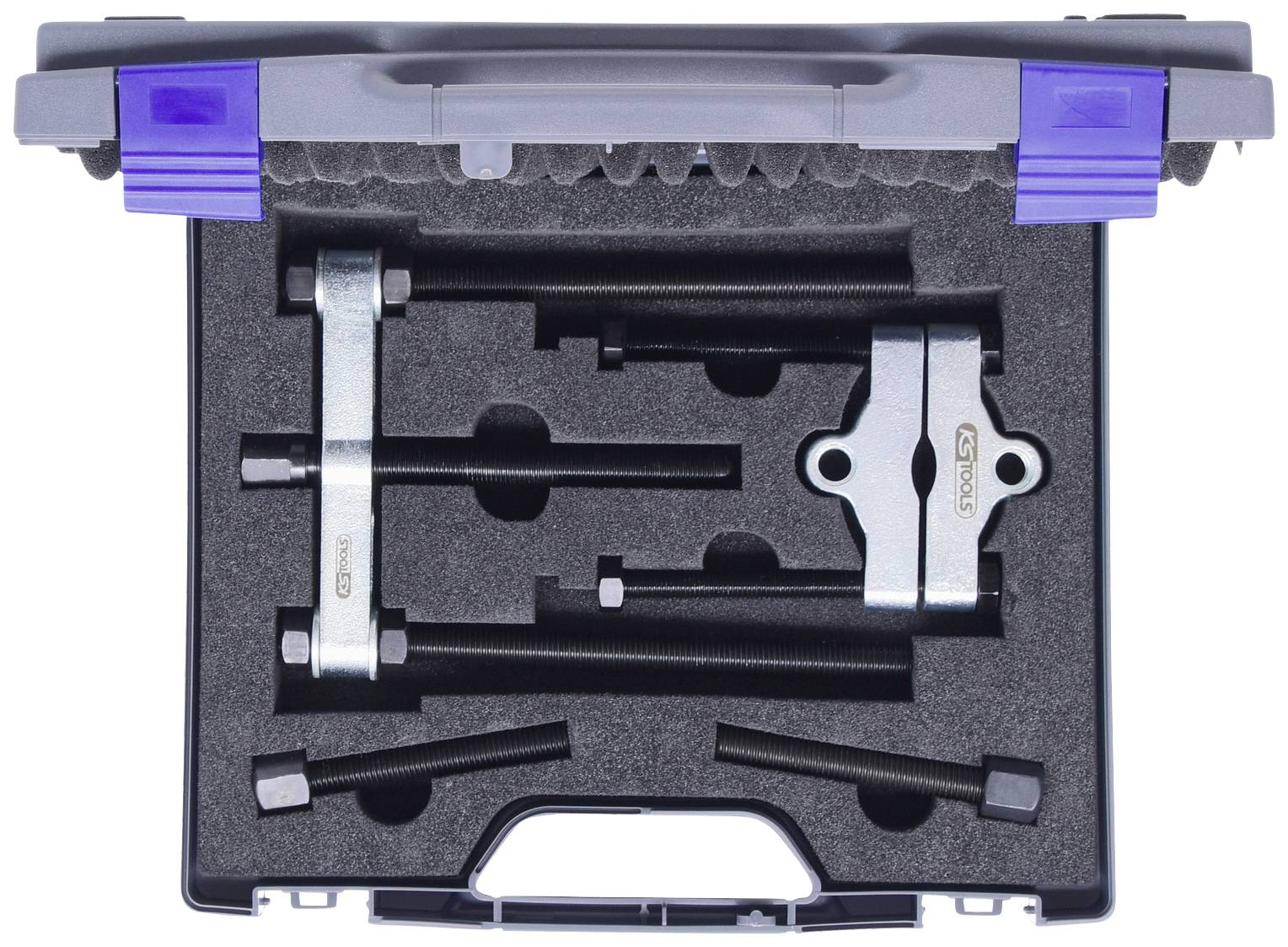 Ein Set von Abziehern in einem Koffer, bestehend aus verschiedenen Metallteilen mit Schraubgewinde, zur Verwendung bei mechanischen Arbeiten.