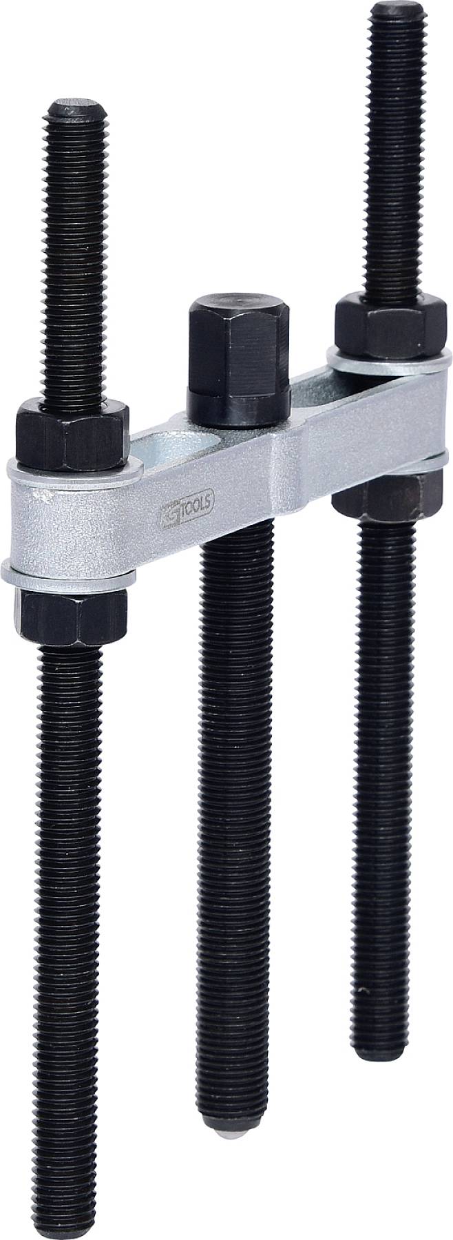 Ein mechanisches Werkzeug mit drei langen Schrauben, ein zentraler Sechskantkopf und ein Metallbalken mit Befestigungsmuttern.