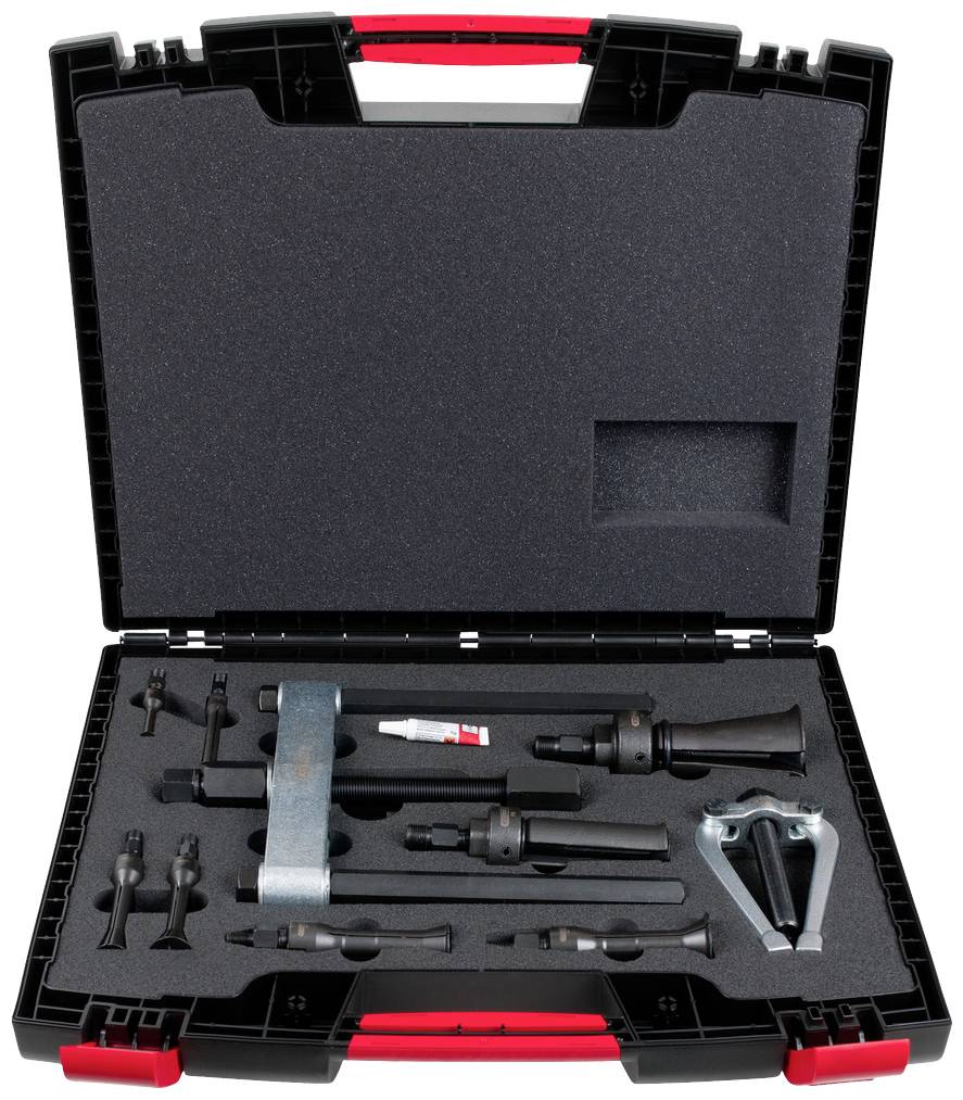 Ein geöffneter Werkzeugkoffer mit verschiedenen Autoreparaturwerkzeugen, darunter ein Abzieher, mehrere Steckschlüssel und ein Schmiermittelröhrchen.