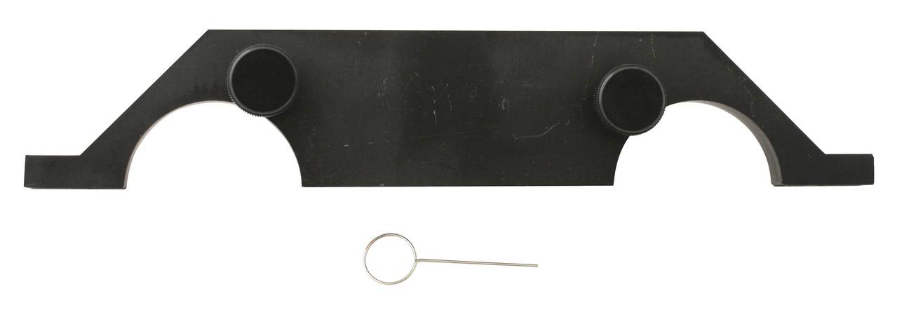 Schwarzes Werkzeug mit zwei runden Erhöhungen an den Enden und einem kleinen Metallstift darunter. Möglicherweise ein Spezialwerkzeug.