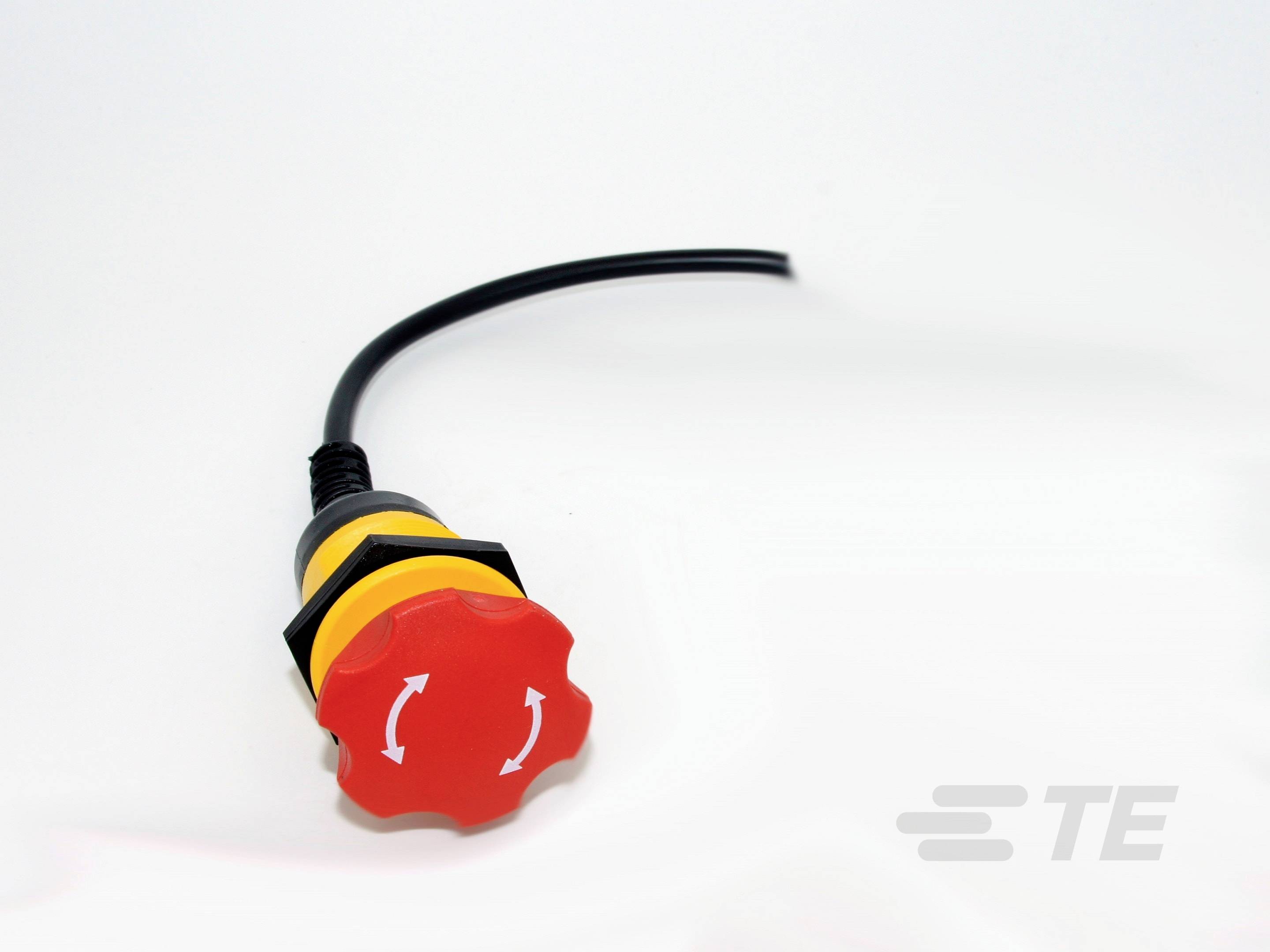 Roter Not-Aus-Schalter mit Pfeilen, montiert an einem schwarzen Kabel.