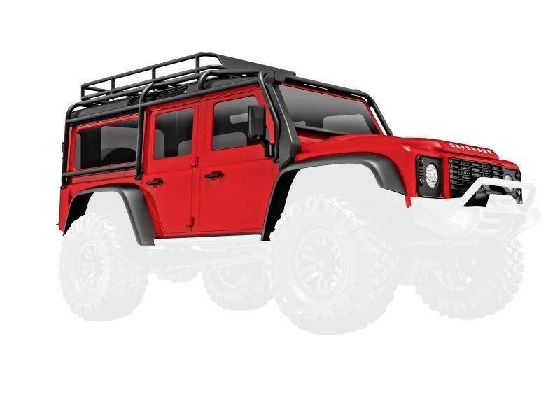 Roter Geländewagen mit Dachgepäckträger und weißem Hintergrund.
