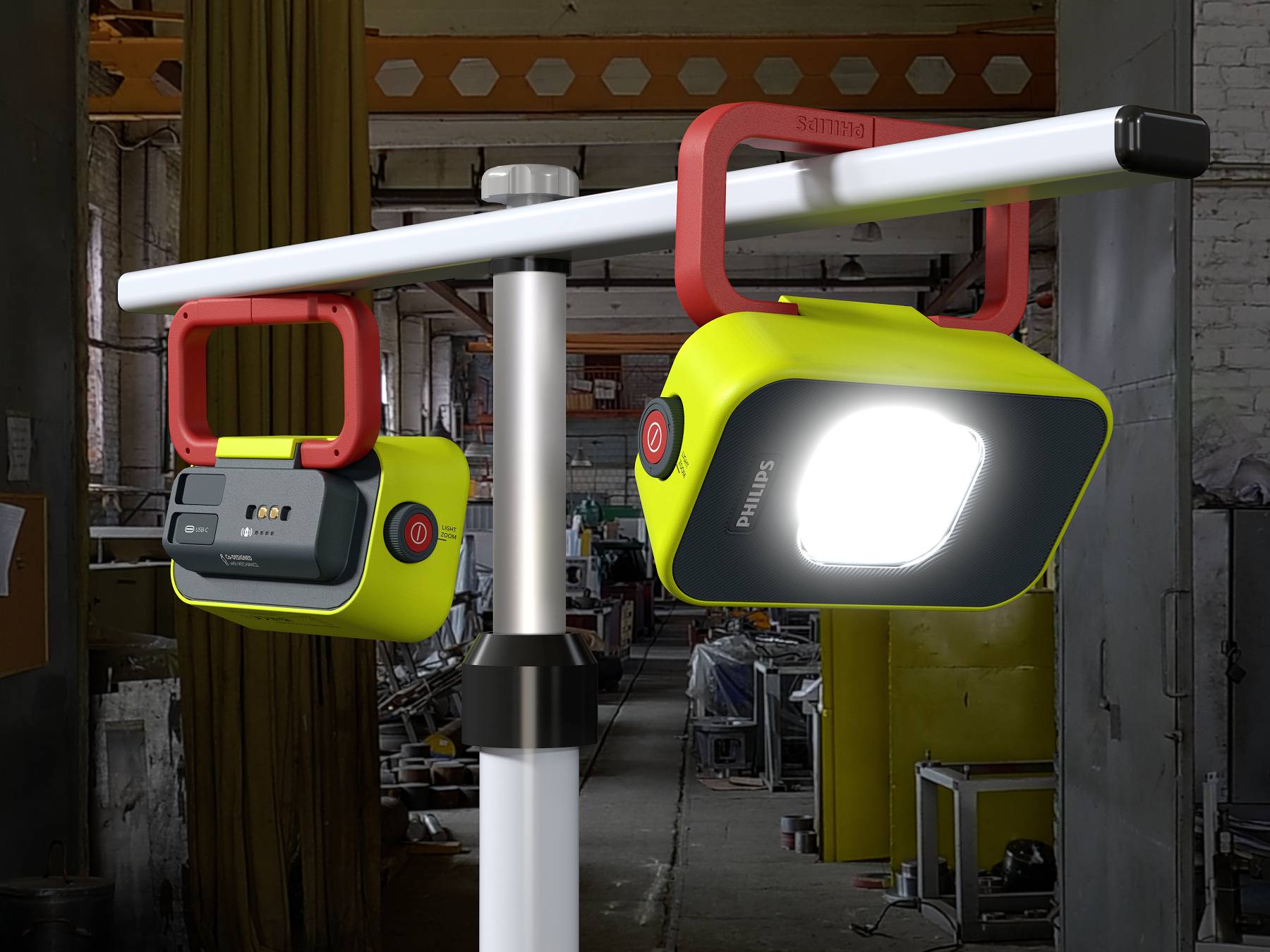 Zwei tragbare LED-Arbeitsleuchten an einem Metallgestell in einer Werkstatt. Eine der Lampen ist eingeschaltet und leuchtet hell.