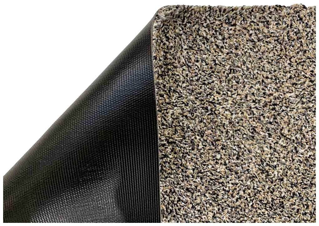 Nahaufnahme einer zweifarbigen Matte: links schwarzer, strukturierter Untergrund; rechts braune, gemusterte Oberfläche.