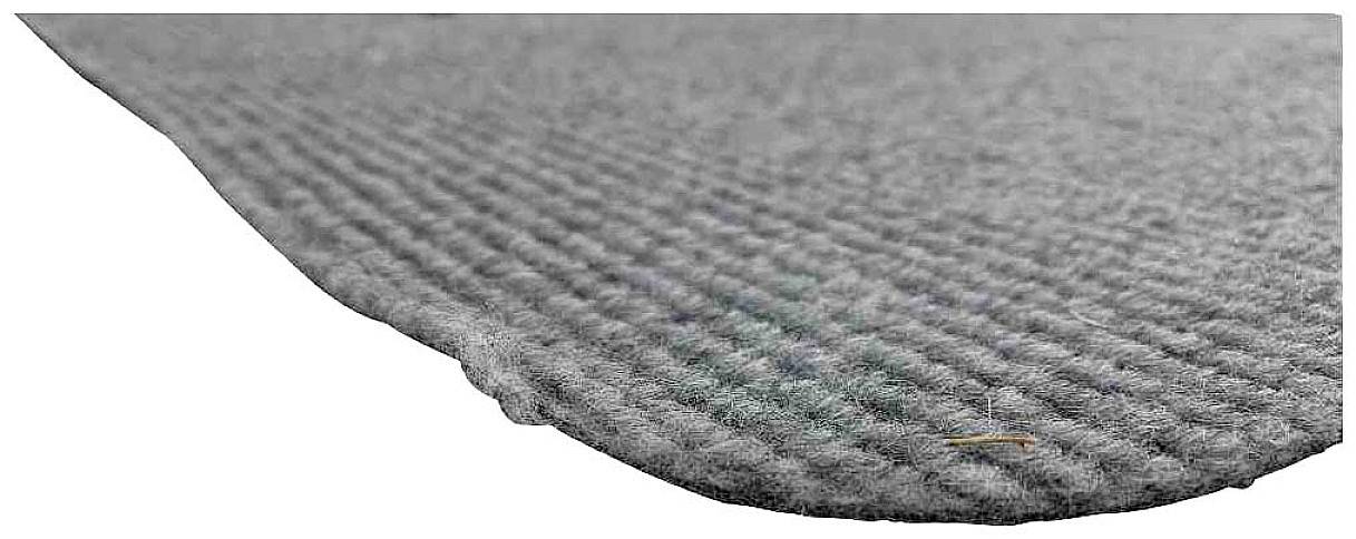 Graue, geriffelte Oberfläche einer Matte in Nahaufnahme; zeigt Textur und Materialbeschaffenheit.