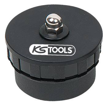Ein schwarzer runder Werkzeugaufsatz mit der Aufschrift 'KG TOOLS' auf der Oberseite. Oben befindet sich eine silberne Schraube.