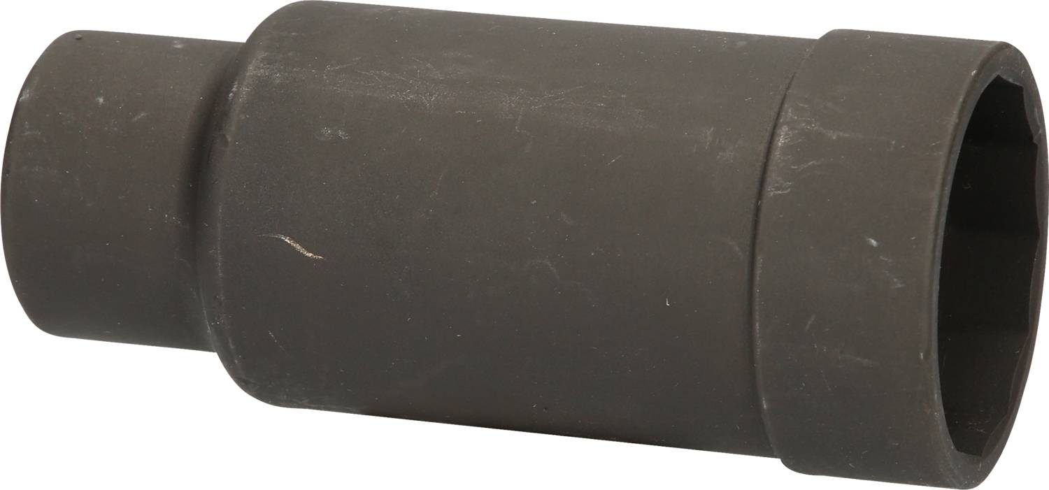 Ein schwarzes, zylindrisches Metallteil, das auf einer weißen Oberfläche liegt.