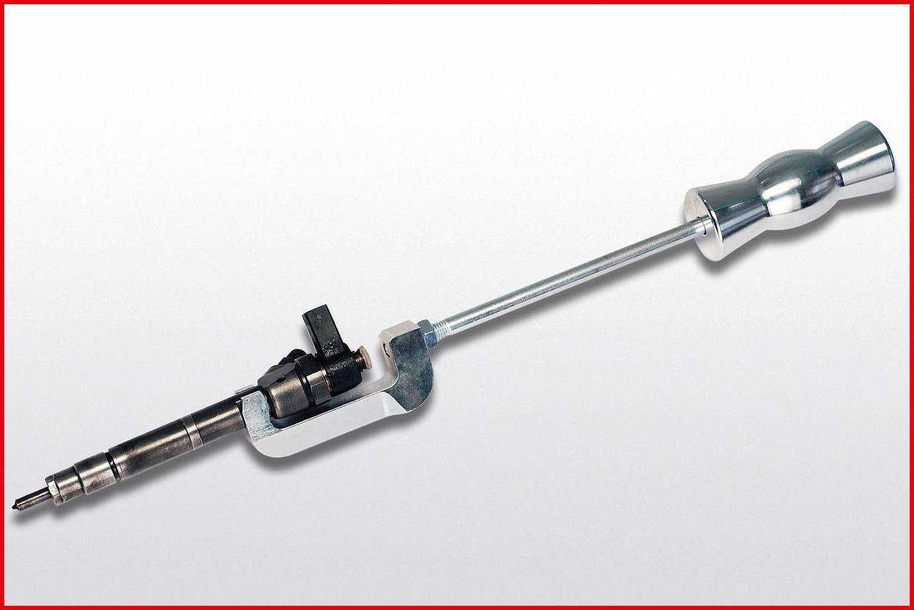 Langmetallisches mechanisches Gerät mit Griff und kleinem Auslöser, dient vermutlich zur Kraftübertragung oder Flüssigkeitszufuhr.