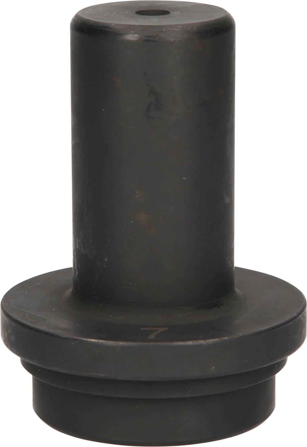 Ein schwarzes, zylindrisches Objekt mit flacher Basis und einem kleineren zylindrischen Abschnitt oben, möglicherweise ein industrielles Teil.