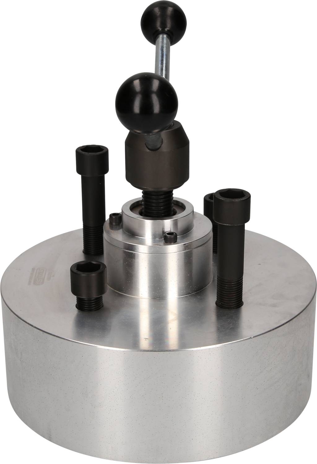 Runde metallische Spannvorrichtung mit mehreren Schrauben und einem Hebel zur Befestigung von Werkstücken in der Fertigung.
