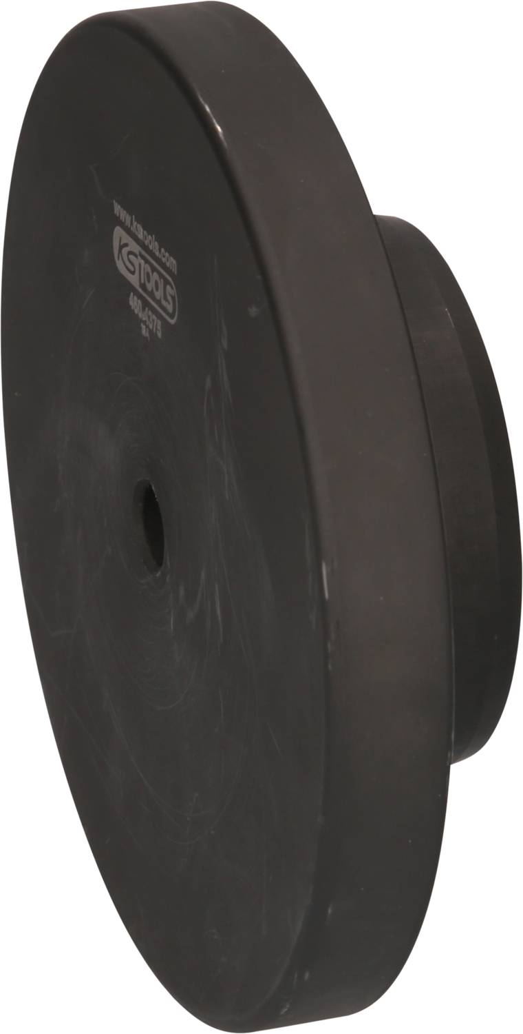 Eine große, schwarze, runde Abdeckkappe aus Kunststoff mit mittigem Loch, wahrscheinlich ein Werkzeugzubehörteil.