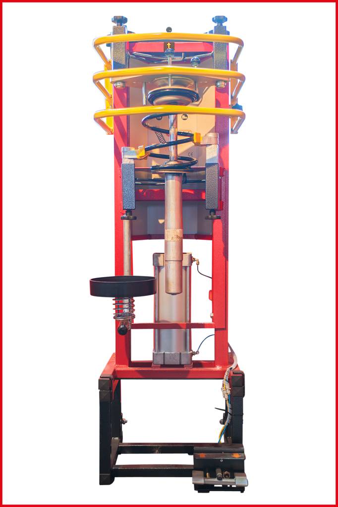 Ein roter vertikaler Maschinenrahmen mit mehreren Federn und einem Servomotor unten. Verwendet für Stoßbelastungstests.