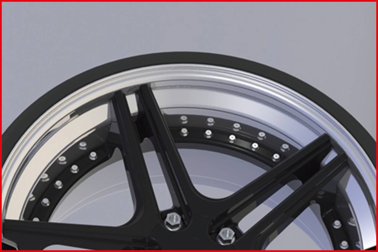 Nahaufnahme eines schwarzen Felgenrandes mit glänzenden Schrauben auf grauem Hintergrund.