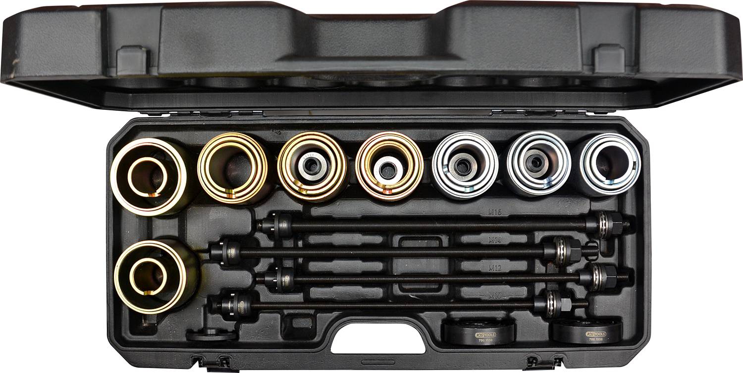 Ein Werkzeugkoffer mit verschiedenen runden Metallaufsätzen und vier schwarzen Stäben. Der Koffer ist geöffnet und alle Teile sind sichtbar.