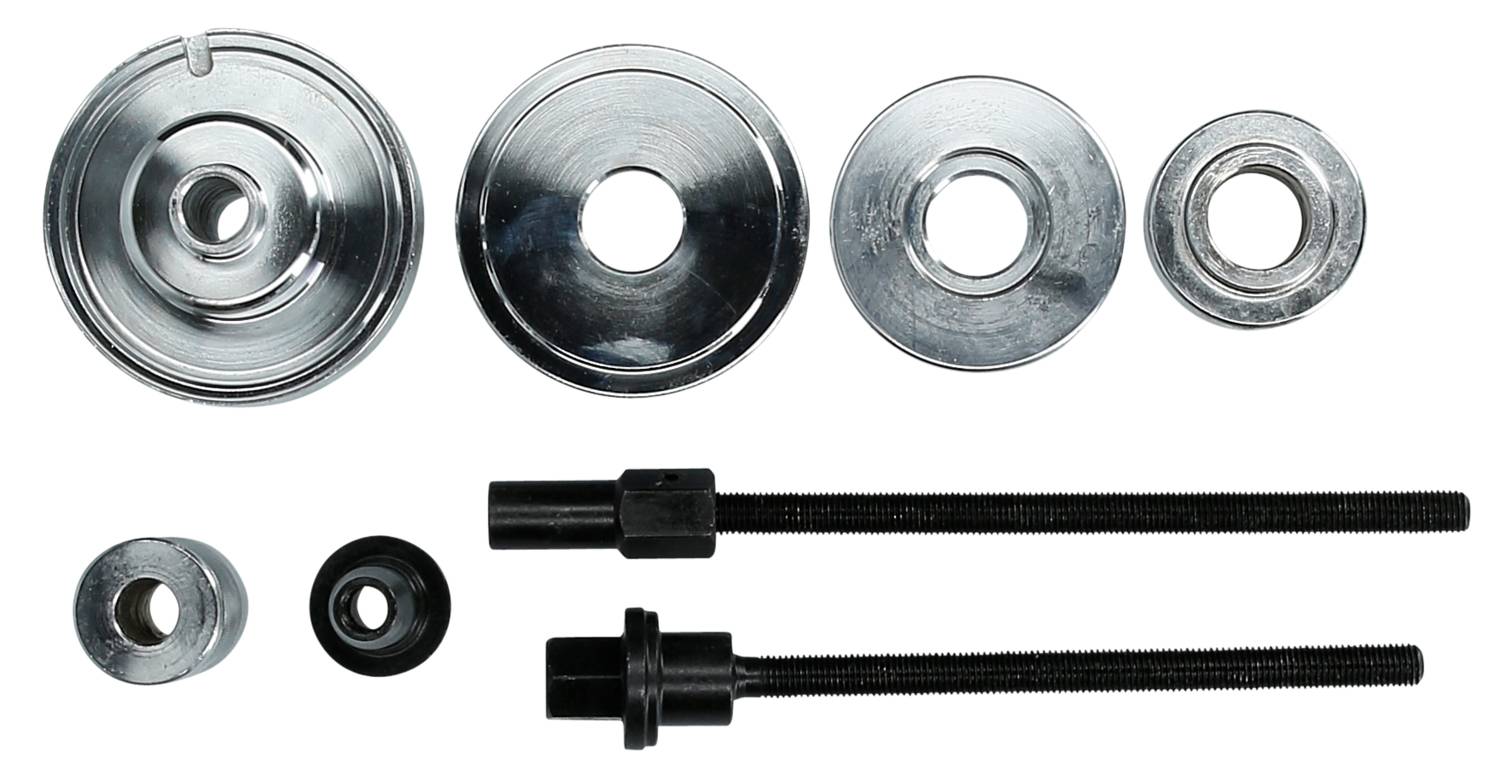 Metallteile und Werkzeuge: Verschiedene runde Scheiben aus Metall und zwei schwarze Gewindebolzen mit passenden Muttern.