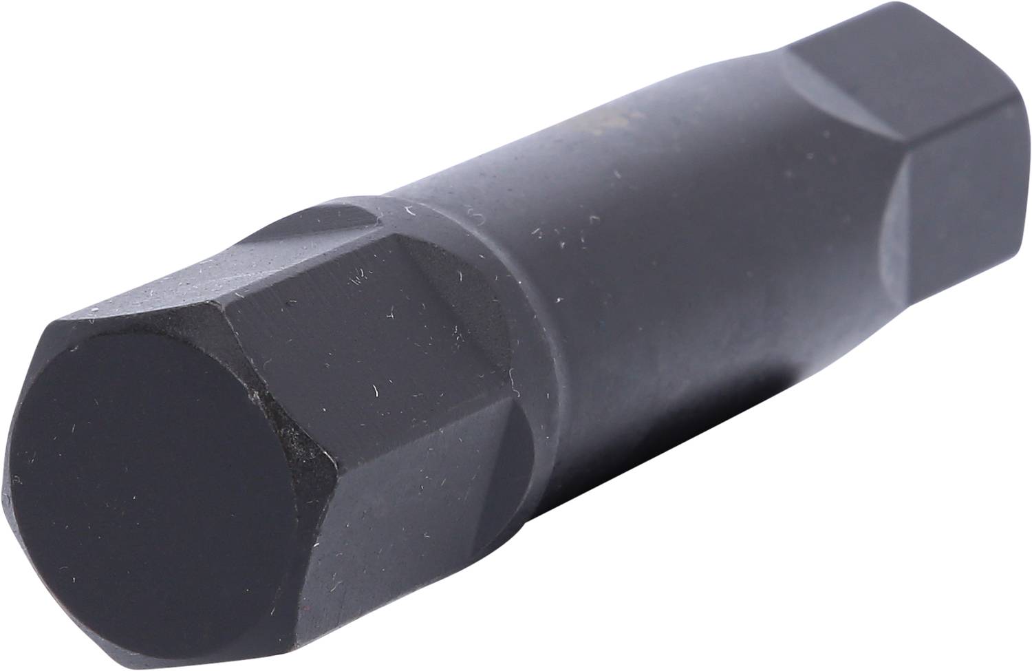 Ein schwarzer Hexantrieb, wahrscheinlich ein Werkzeugaufsatz, liegt schräg und zeigt seine sechsseitige Form.