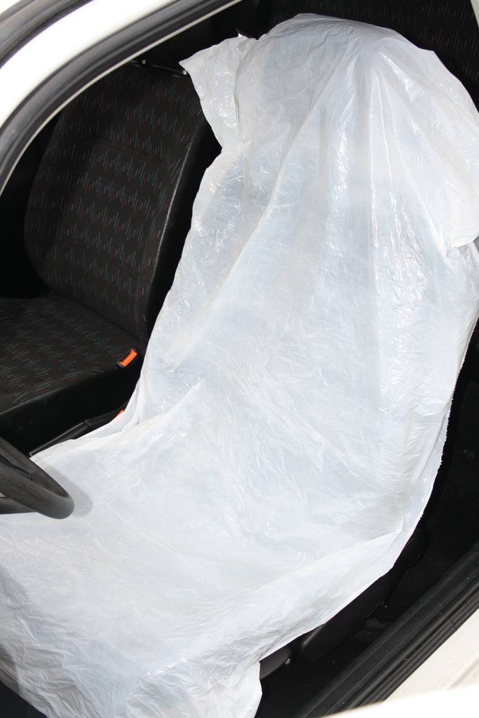 Autositz mit Schutzabdeckung aus Plastik; verhindert Verschmutzung während Reparatur oder Wartung.