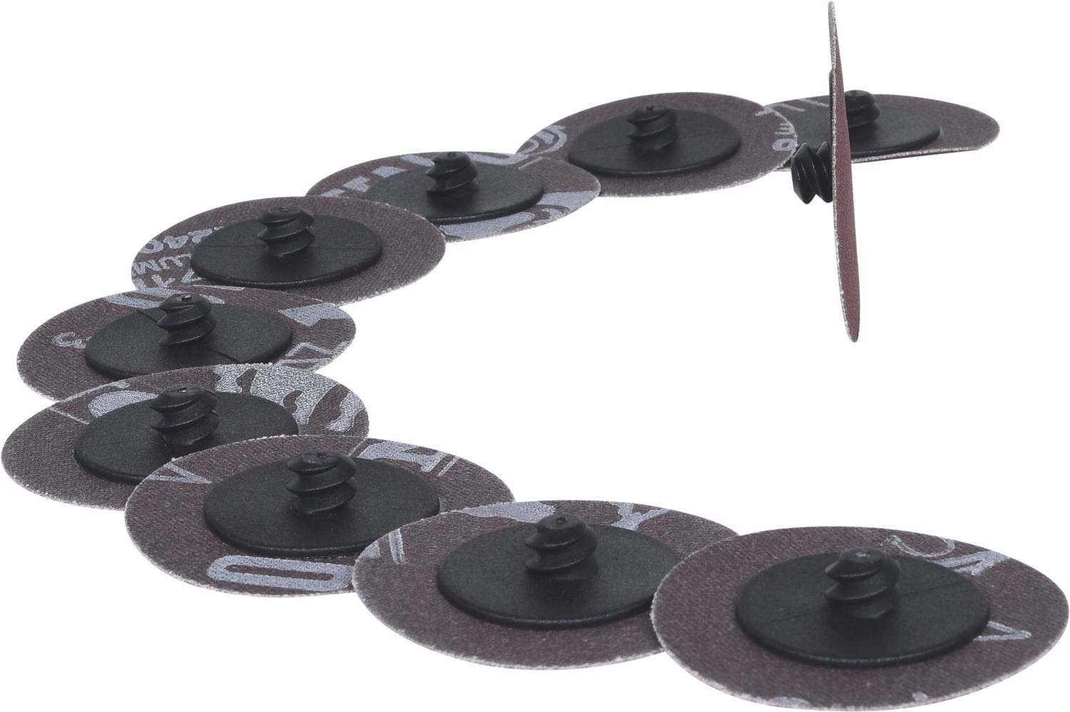 Eine Reihe von runden Schleifscheiben mit Befestigungsnoppen, die in einer geschwungenen Linie aufgestellt sind.