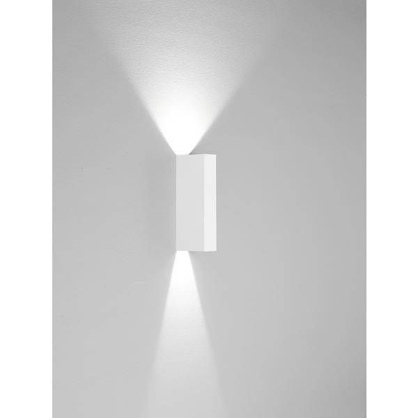Wandleuchte mit modernem Design strahlt Licht nach oben und unten ab und erzeugt sanfte Lichtkegel an der grauen Wand.
