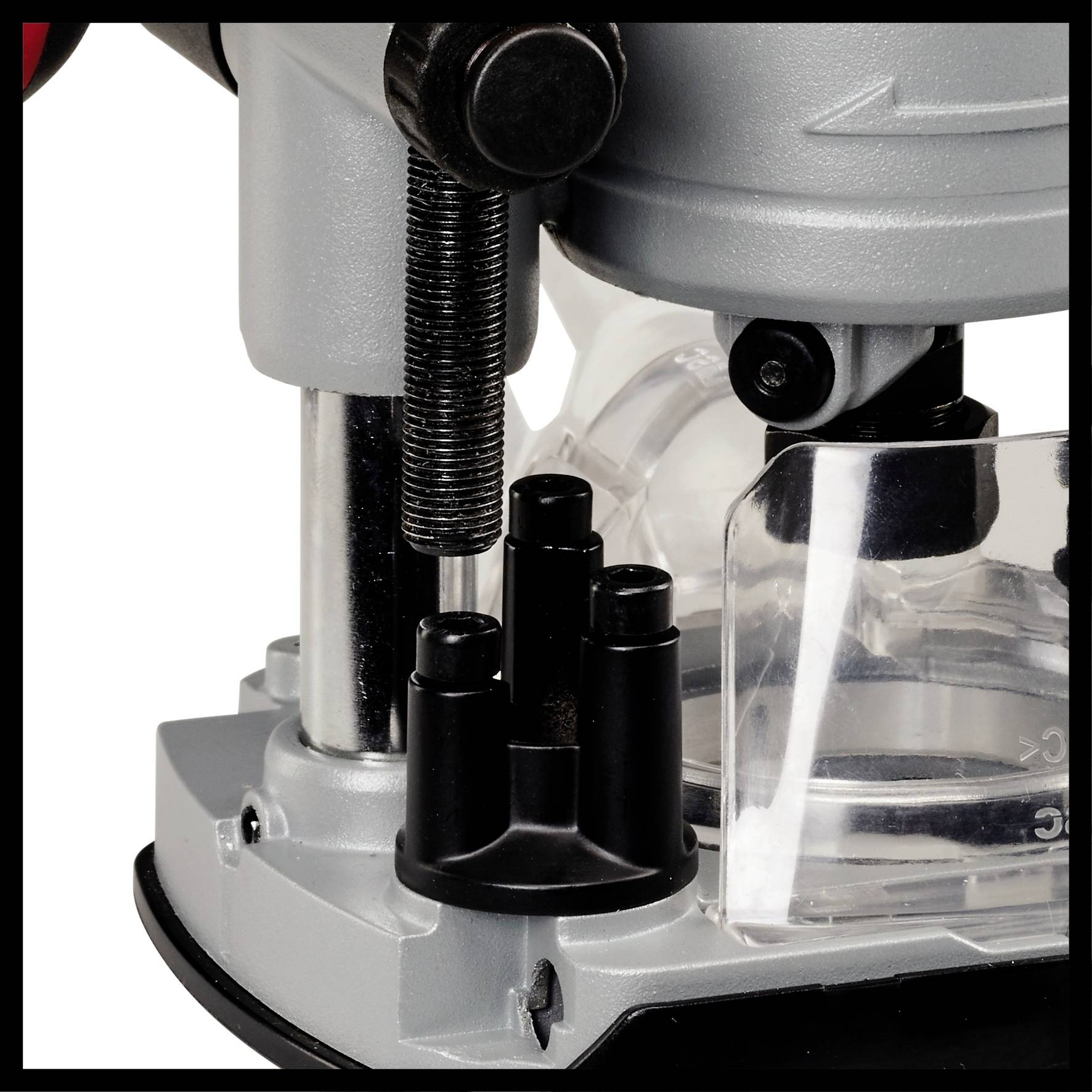 Ein Detail einer mechanischen Vorrichtung, möglicherweise eine Maschine oder ein Werkzeug, mit Metall- und Kunststoffkomponenten.