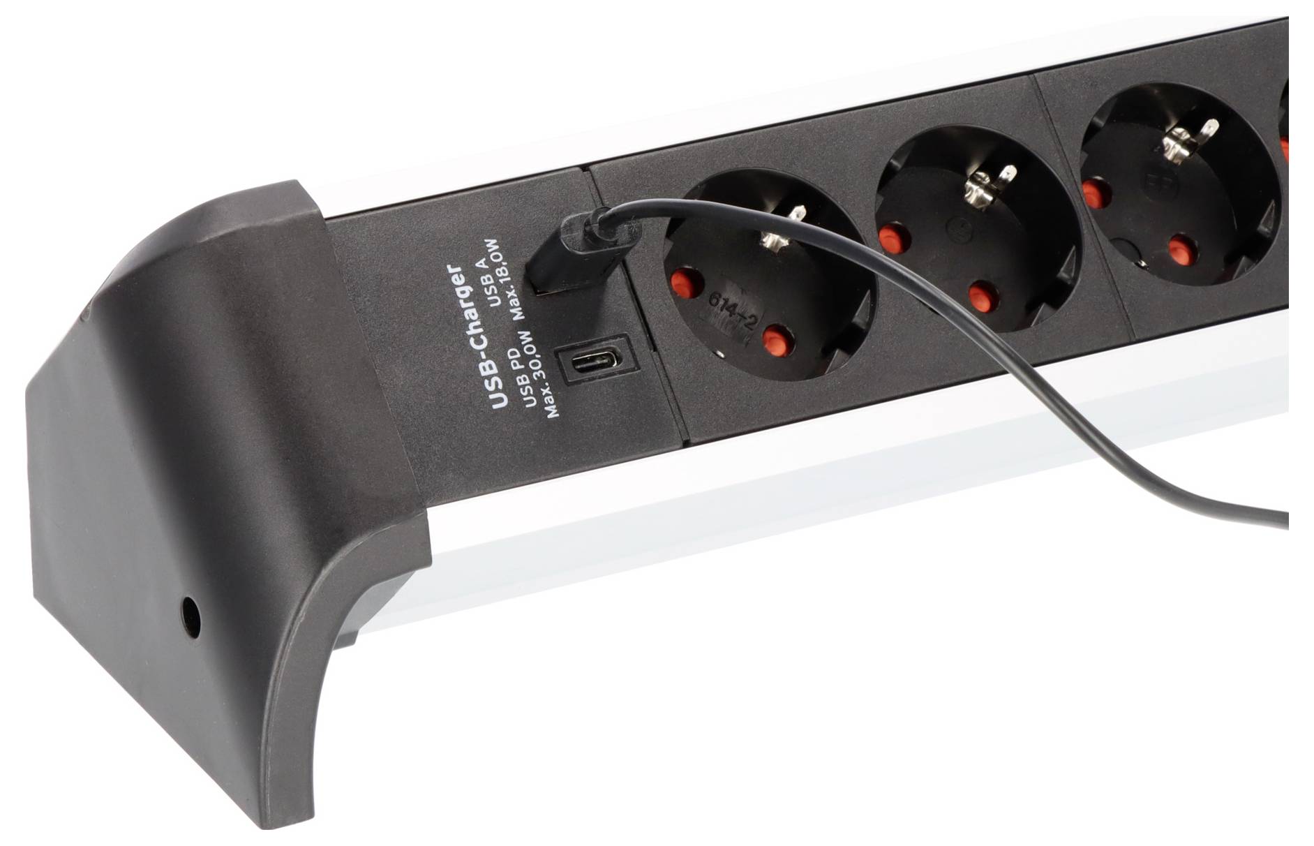 Schwarze Steckerleiste mit sechs Steckdosen und USB-Ladegerät mit angeschlossenem Kabel, auf weißem Hintergrund dargestellt.
