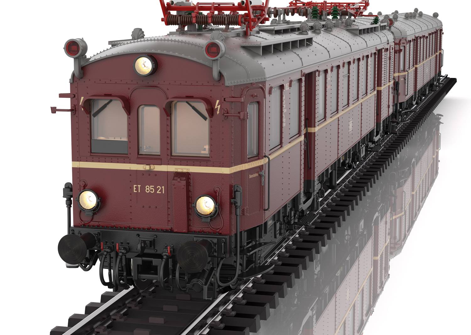 Historischer roter Triebwagen mit Scheinwerfern auf Gleisen, Vorderansicht. Der Wagen hat Fenster, Bogendach und Oberleitungen.