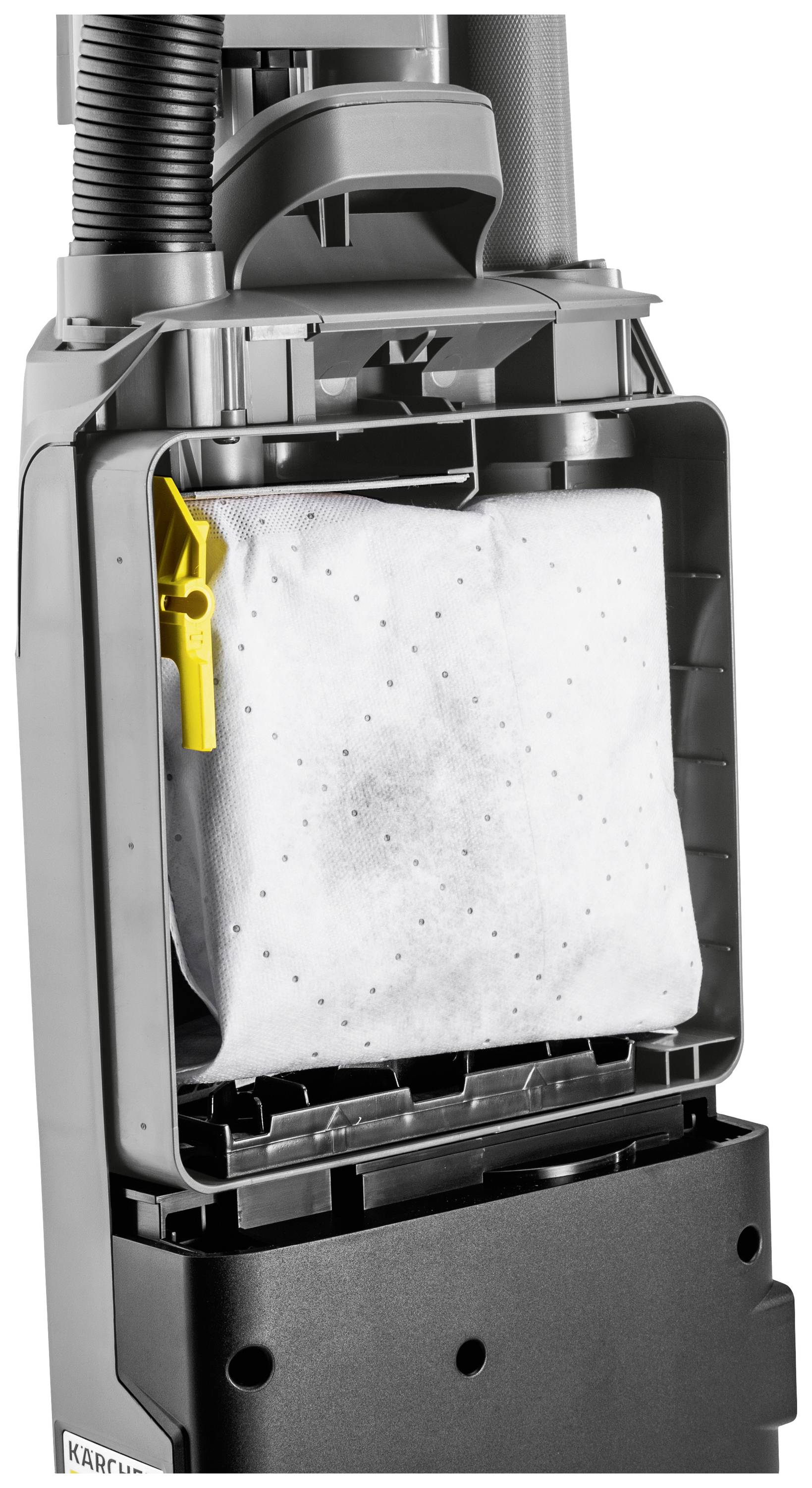 Ein Staubsauger mit offenem Fach, das den Staubbeutel und seine Halterung zeigt. Der gelbe Clip auf der linken Seite ist deutlich sichtbar.