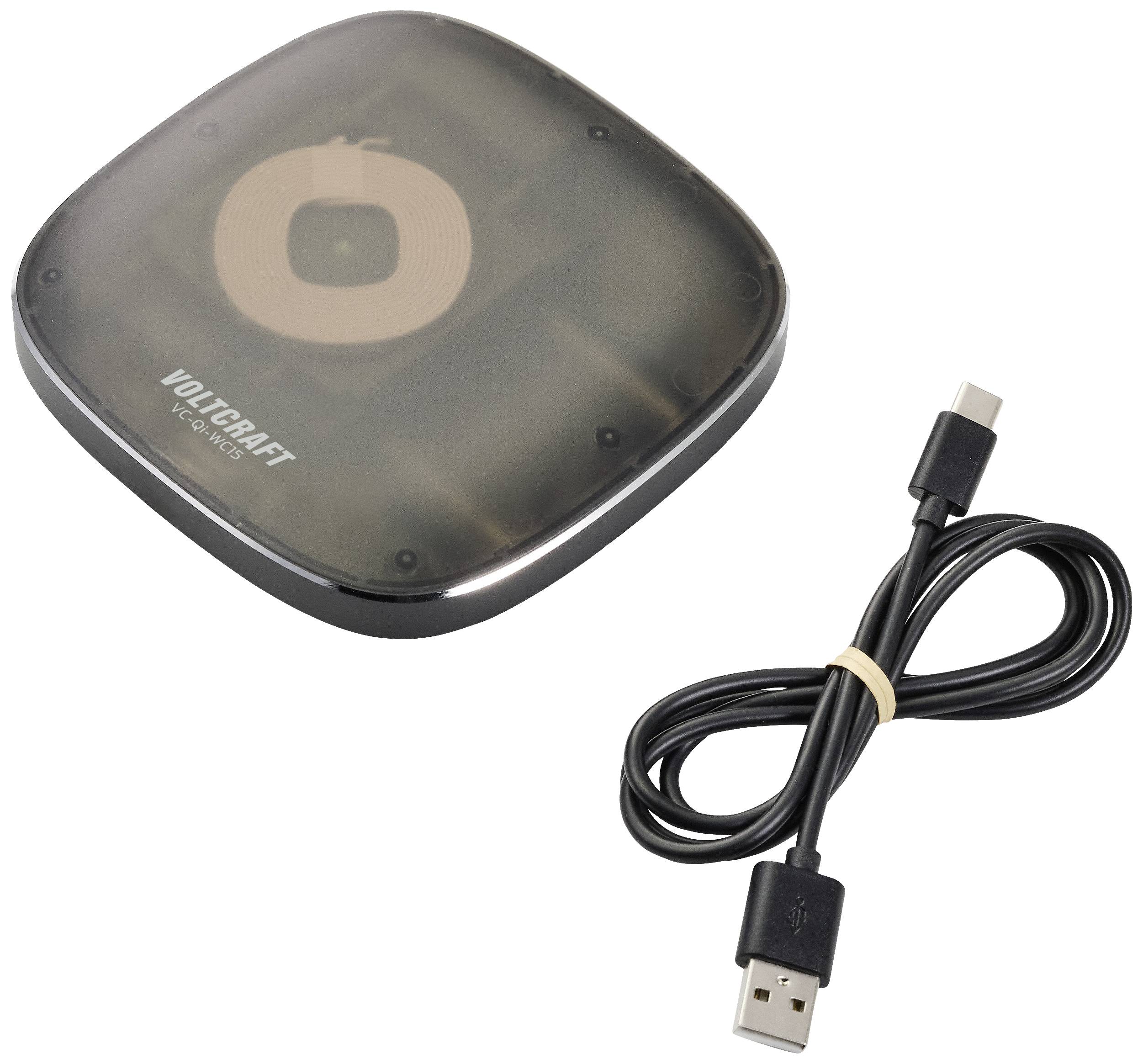 Ein kabelloses Ladegerät neben einem USB-C-Kabel. Das Ladegerät hat ein dunkles, glänzendes Gehäuse und die Marke 'Voltcraft' ist erkennbar.