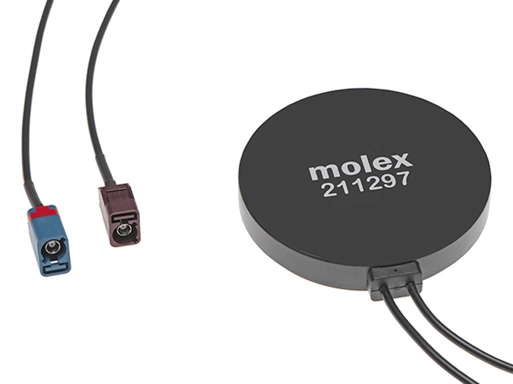 Rundes elektronisches Gerät mit der Aufschrift 'molex 211297', verbunden mit zwei verschiedenen farbigen Steckverbindern an Kabeln.