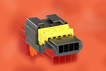 Ein schwarzer und gelber elektronischer Steckverbinder vor einem orangefarbenen Hintergrund.