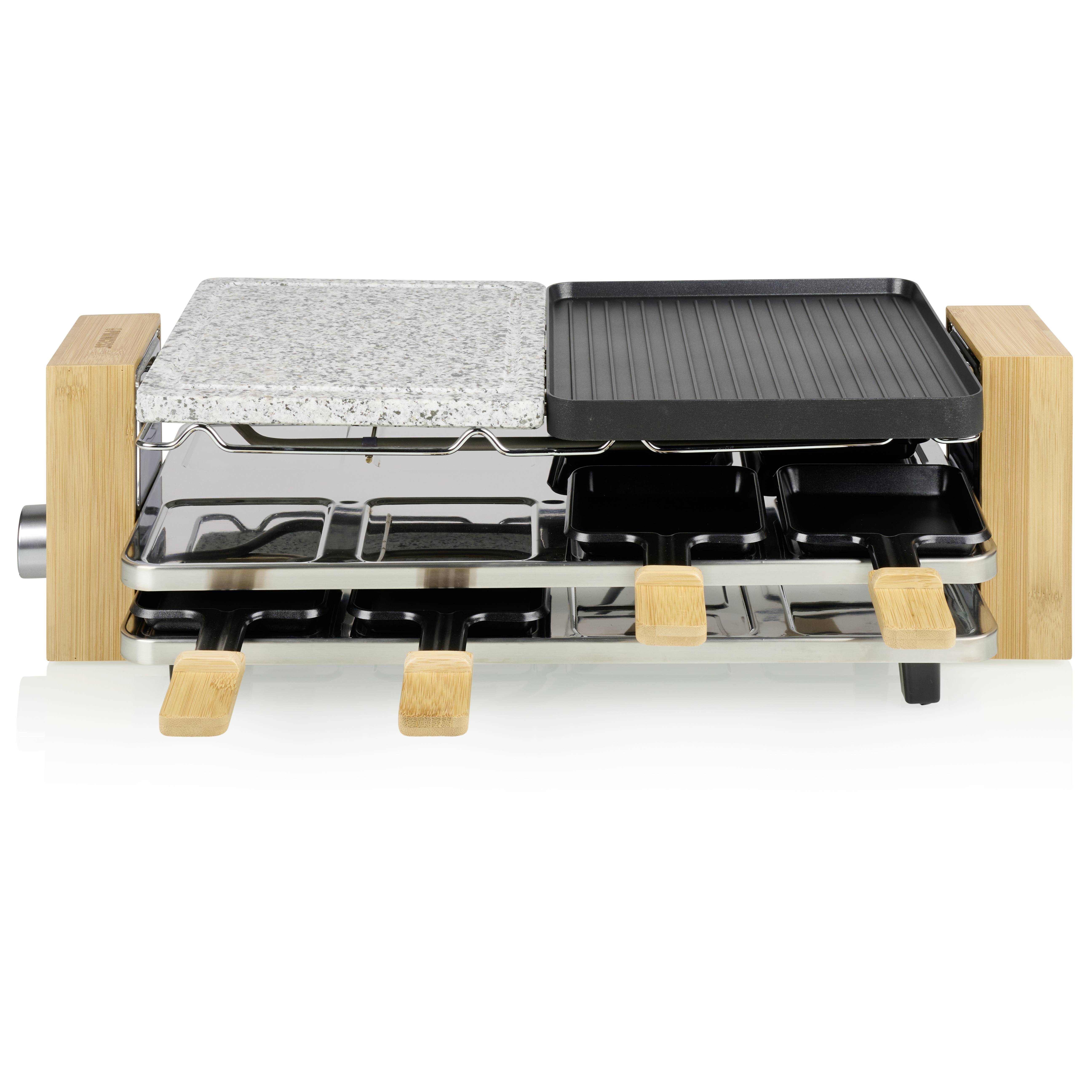 Ein Tischgrill mit zwei Grillplatten: eine aus Stein und eine geriffelte Metallplatte. Darunter befinden sich kleine Pfännchen.