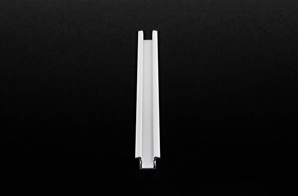 Ein weißer, länglicher U-förmiger Kunststoffkanal auf schwarzem Hintergrund.