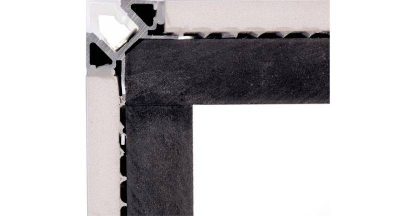 Ein Querschnitt einer Baukonstruktion zeigt verschiedene Schichten und Materialien, darunter eine schwarze Dichtung in der Ecke.