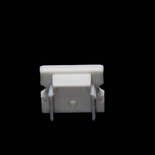 Weißes, rechteckiges Objekt vor schwarzem Hintergrund, möglicherweise ein technisches Bauteil oder Adapter.