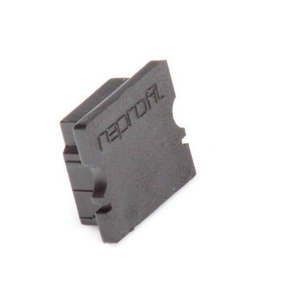 Ein schwarzer Kunststoffblock mit dem eingeprägten Text 'reproril'.