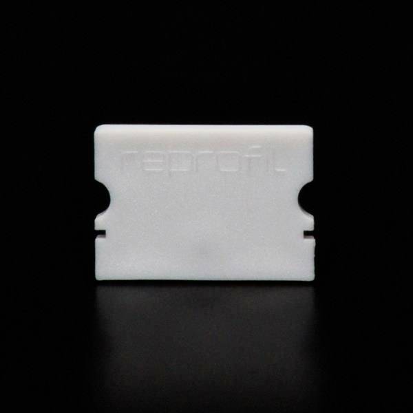 Ein weißes Objekts auf schwarzem Hintergrund, rechteckig mit zwei Einkerbungen an den Seiten.