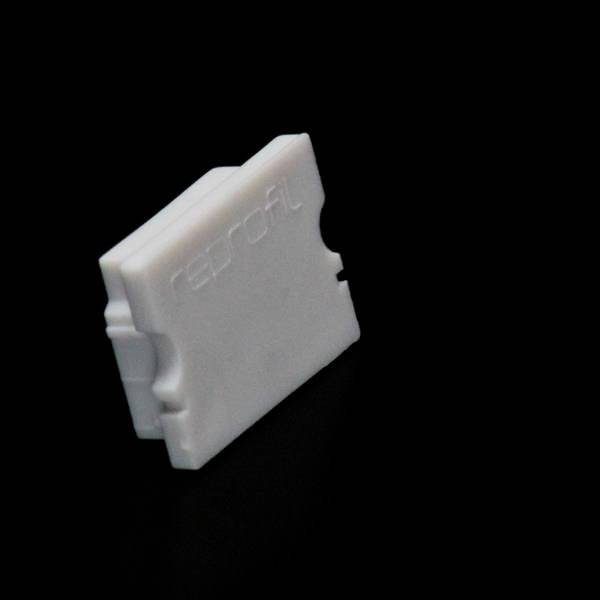 Ein weißer, rechteckiger Kunststoffblock mit dem Schriftzug 'reproFL' auf der Oberfläche. Der Block steht auf einer schwarzen Oberfläche.