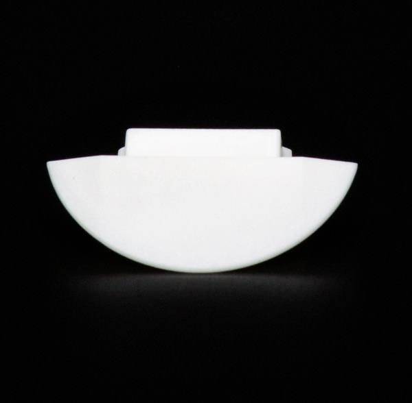 Ein weißes, halbrundes Objekt mit einer flachen Oberseite auf schwarzem Hintergrund.