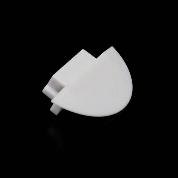 Ein weißer Kunststoffclip in Halbkreisform vor schwarzem Hintergrund.