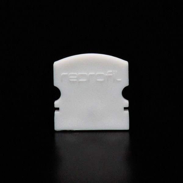 Ein weißes Kunststoffteil mit der Aufschrift 'reprofil', vor schwarzem Hintergrund.